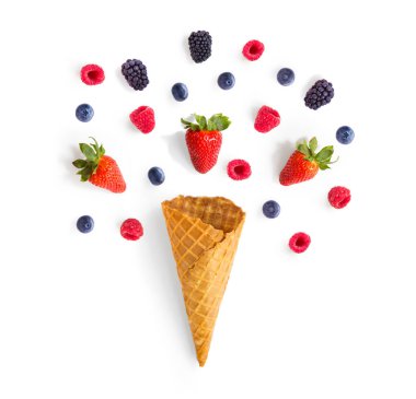 Ice cream cone with strawberry, raspberry, blueberry and blackberry . Flat lay. Food concept.