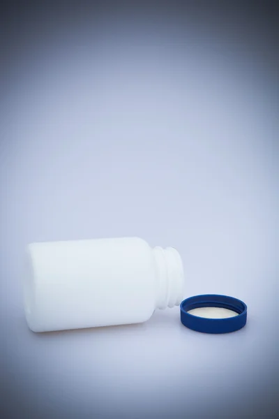 Small white medecine bottle — Stock Photo, Image