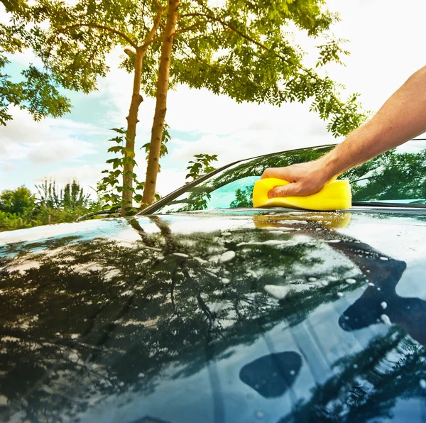 Hand car wash with yellow sponge — Stock Photo, Image