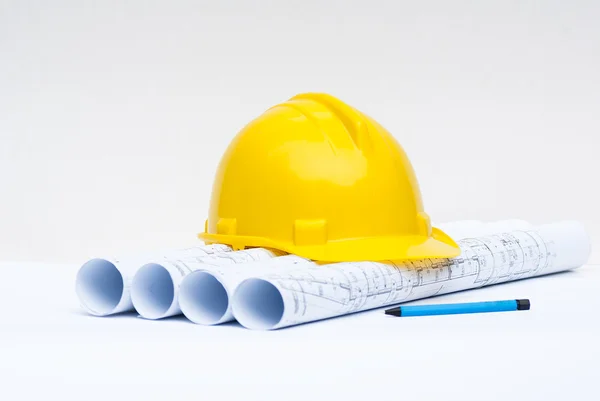 Construction helmet and architectural plans — Stock Photo, Image