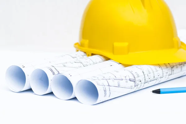 Construction helmet and architectural plans — Stock Photo, Image