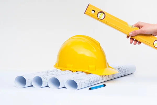 Architectural projects with yellow construction helmet — Stock Photo, Image