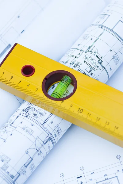 Spirit level and architectural drawings Stock Photo