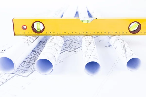 Construction level and blueprints — Stock Photo, Image