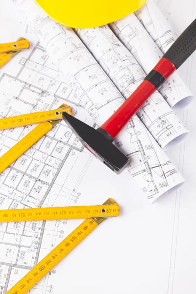 Red hammer and construction tool with architectural drawing — Stock Photo, Image