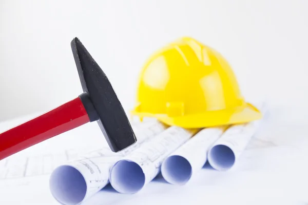 Red hammer and construction tool with architectural drawing — Stock Photo, Image