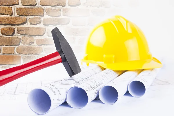 Red hammer and construction tool with architectural drawing — Stock Photo, Image