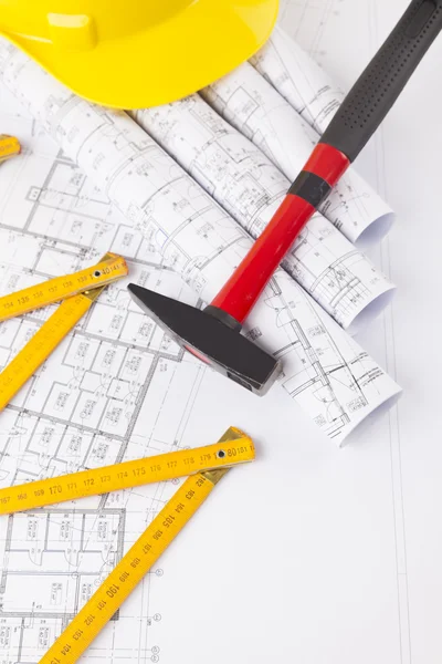Red hammer and construction tool with architectural drawing Royalty Free Stock Photos