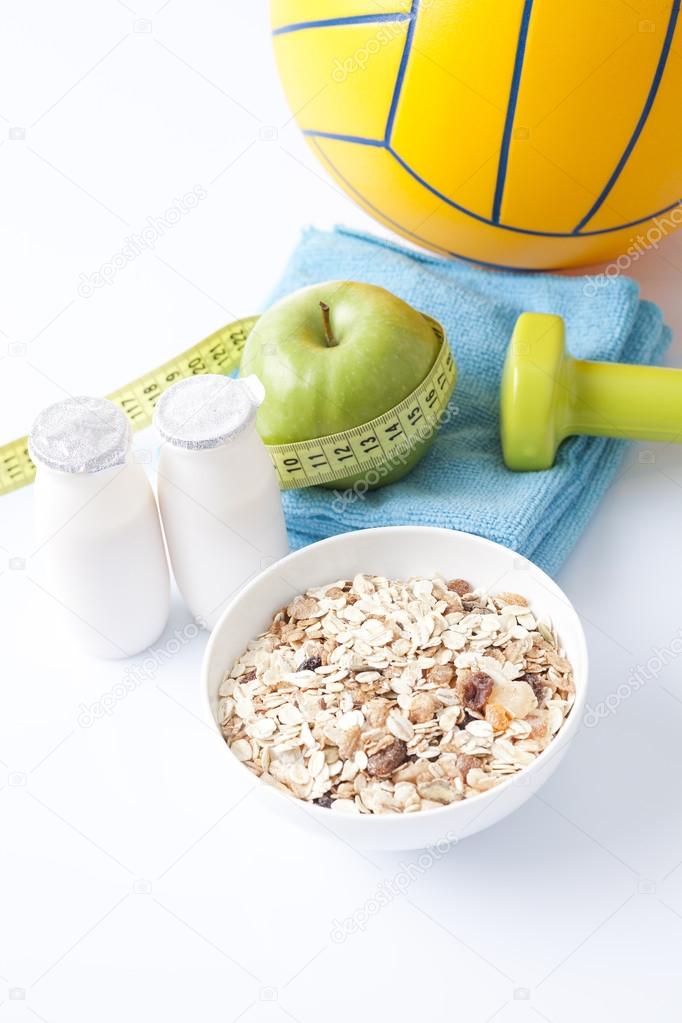 Healthy food and sport equipment isolated on white