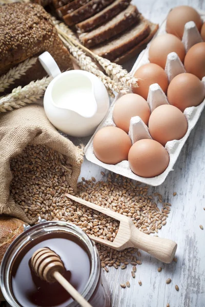 Ingredients for cooking, eggs, honey, bread, flour and milk — Stock Photo, Image