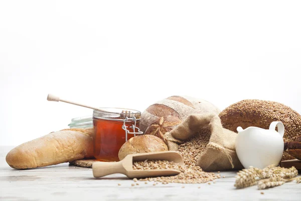 Vintage jug, bread and  seeds,isolated — Stock Photo, Image