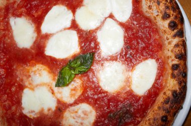 Pizza Margherita with basil close up