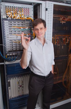 Network engineer in server room clipart