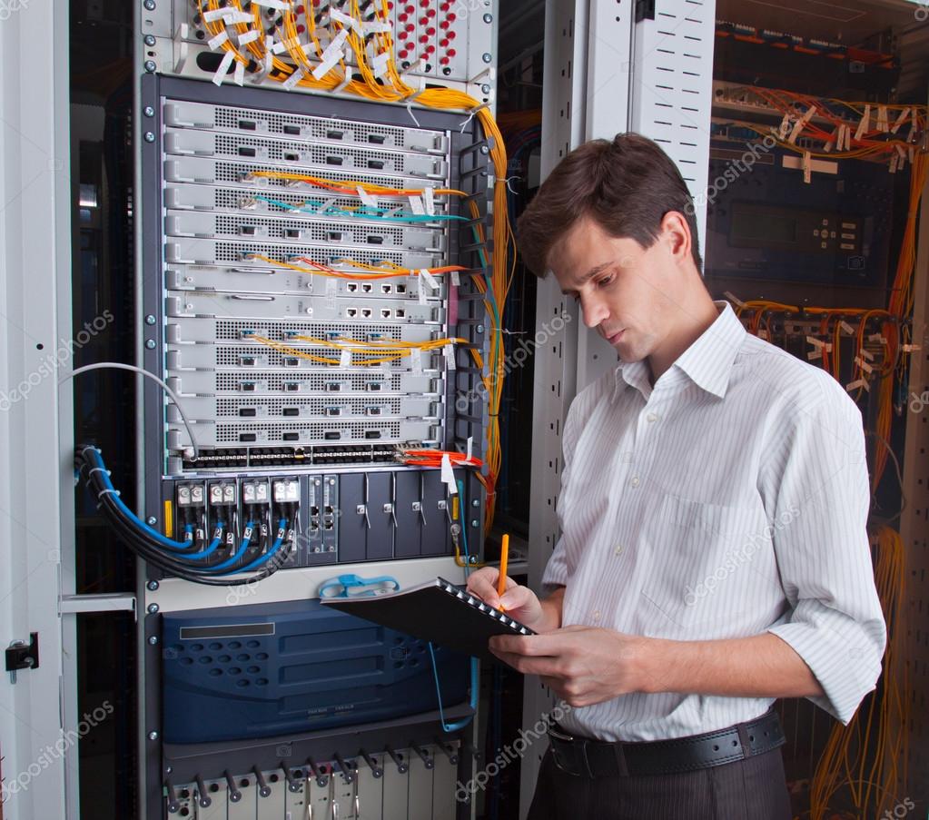 Network Engineer In Server Room Stock Photo Bumi100 25339195 network-engineer-in-server-room-stock-photo-bumi100-25339195