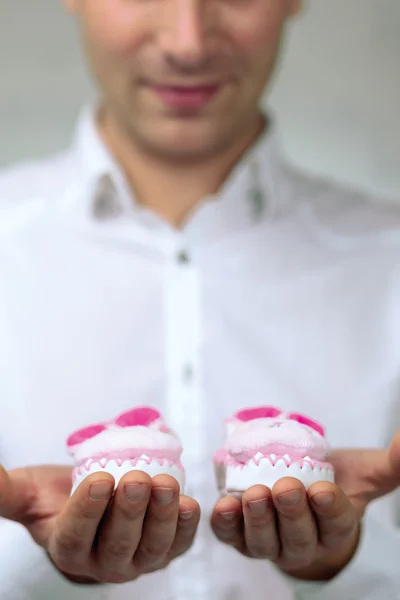 Jeune homme tenant des chaussons bébé — Photo