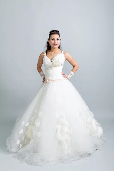 Girl in a white wedding dress hands on belt — Stock Photo, Image