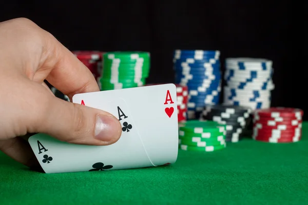 Player checks his hand, two aces in, focus on card — Stock Photo, Image