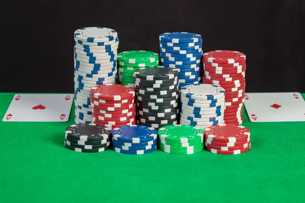 Pair aces and poker chips stack on green table — Stock Photo, Image