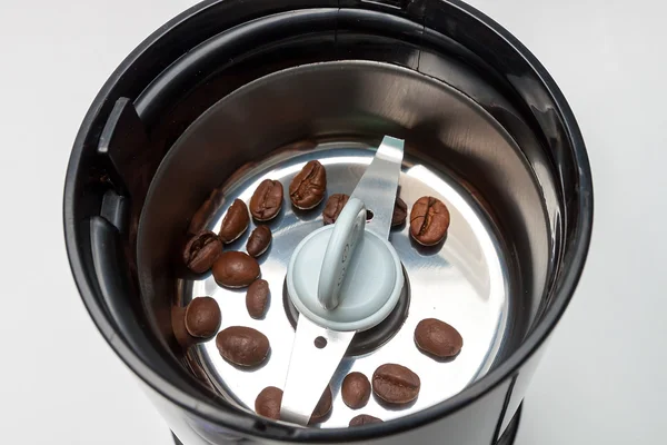 Electric grinder machine with roasted coffee beans — Stock Photo, Image