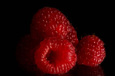 Forest fruits - raspberries on black background