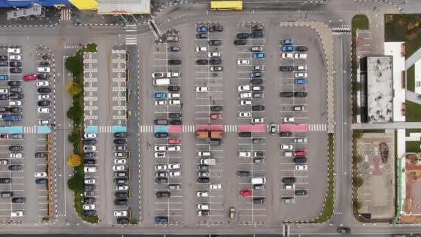 Aerial view of a large paved parking lot near the shopping center filled with cars — Stock Video