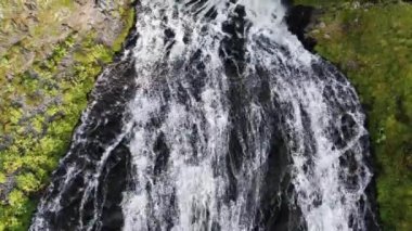 Kara sarp kayalıkların üzerinde yüksek dağlık şelale