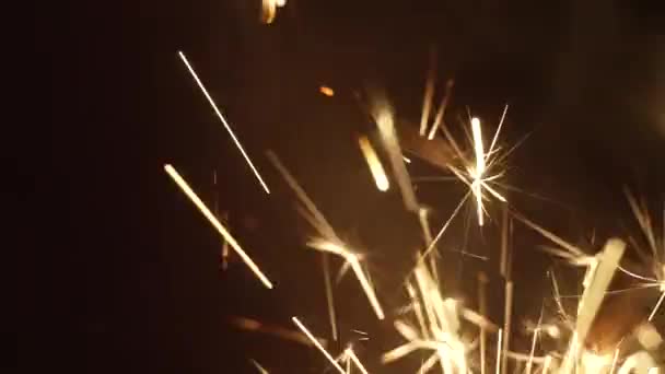 Bright sparks of sparkler shining vividly in dark room — 图库视频影像