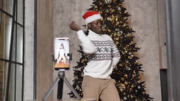 Black man dances filming video via phone in festive mood — Stockvideo