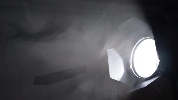 Puffs of smoke move slowly in the beams of the cinema light — Video