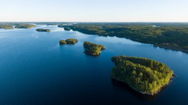 Small islands with a forest in the middle of a large lake aerial view
