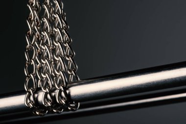 abstract stainless steel chain on the metal bar