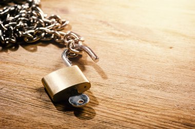 closeup stainless steel chain and padlock, security concept