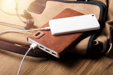 Akıllı telefon beyaz güç bankasıyla şarj ediliyor. Beyaz güç bankasına yakın çekim. 