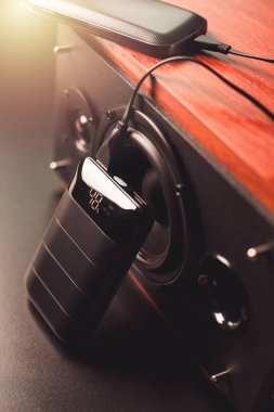 Akıllı telefonun bataryasını siyah güç bankasıyla şarj etmek. Güç bankası görüntüsüne odaklanmış sığ alan derinliği.