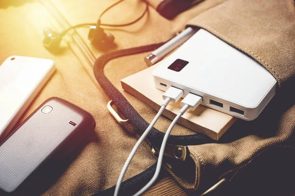 smartphone charging with white power bank. close-up at white power bank.