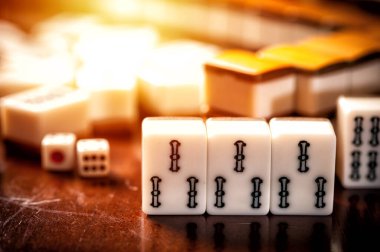 Many old mahjong tiles on wooden table. Mahjong is the ancient asian board game.