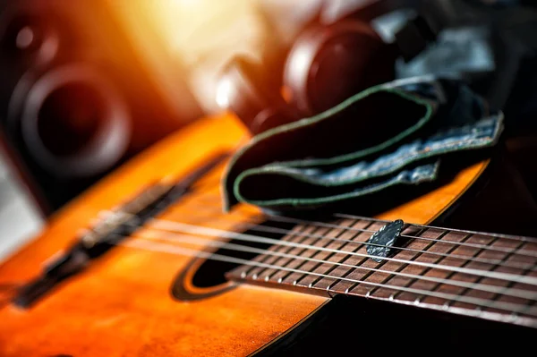 Closeup guitar pick on an old classical guitar. A guitar pick is a plectrum used for guitars.