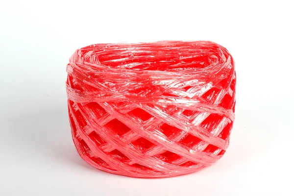 Roll red plastic ribbon on white background — Stock Photo, Image