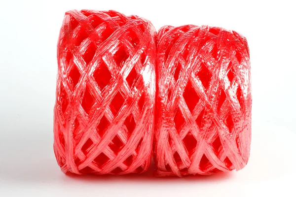 Roll red plastic ribbon on white background — Stock Photo, Image