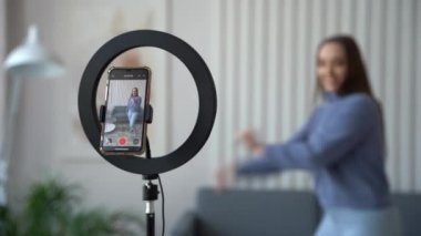 Genç bayan blogcu sosyal ağ ya da kişisel kanal için dans videosu kaydediyor, evinde eğleniyor..