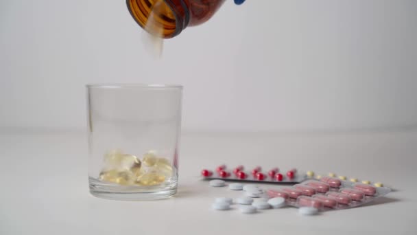液体凝胶胶囊从罐子里撒在玻璃杯里 生产有机营养补充剂和药品 健康饮食概念 图库视频片段