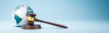 Judges Gavel and Earth Planet on Blue Background with Copy Space 3D Render Illustration
