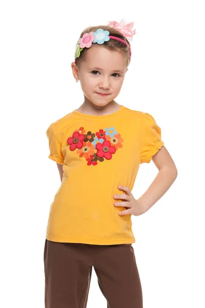 Thoughtful little girl in yellow shirt — Stock Photo, Image