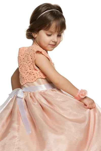 Thoughtful little girl in a ball gown — Stock Photo, Image