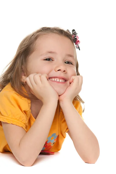 Smiling small girl in a yellow shirt — Stock Photo, Image