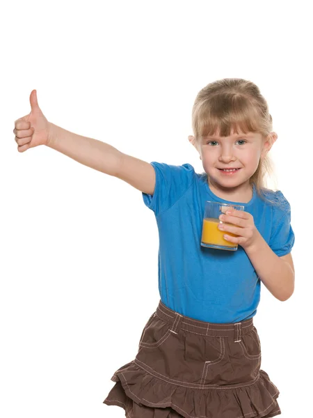 Smiling little girl with a glass of orange juice — Stock Photo, Image