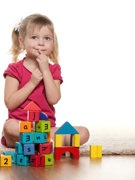 Pensive little girl near toys Stock Image