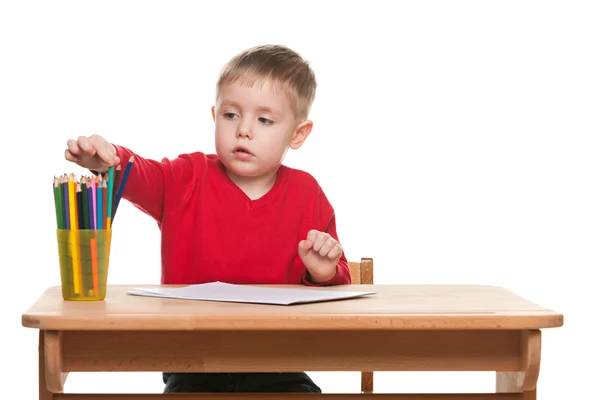 Little boy writes at the desk — Stock Photo, Image