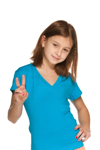 Pretty girl makes a victory sign — Stock Photo, Image