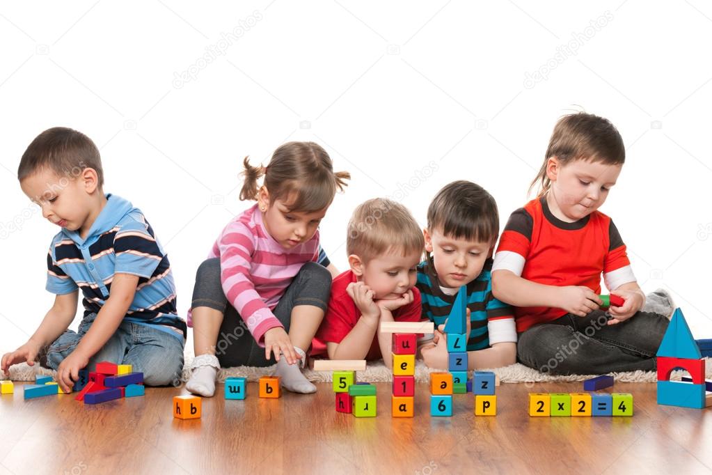 Five kids playing on the floor